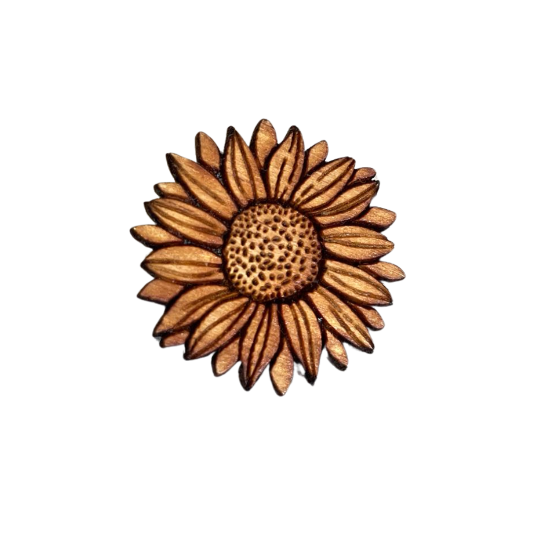 A wooden pin shaped like a sunflower with a brown color.