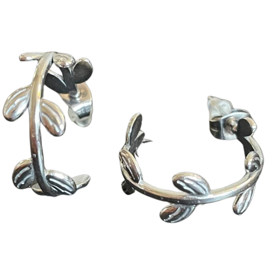 Silver hoop earrings with a stem or vine like pattern.