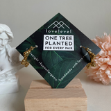 Gold-hoop earrings on a green card with 'lovelevel' branding