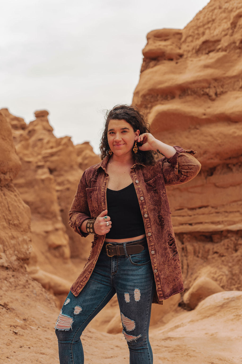 Person standing in a desert landscape with rock formations