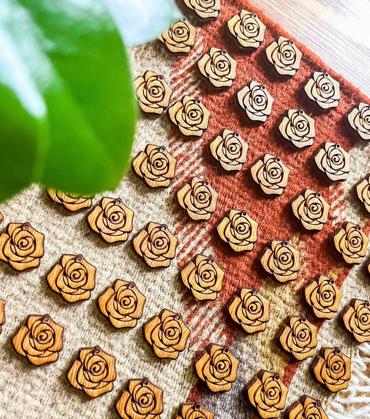 Wooden rose-shaped pins on a textured fabric background