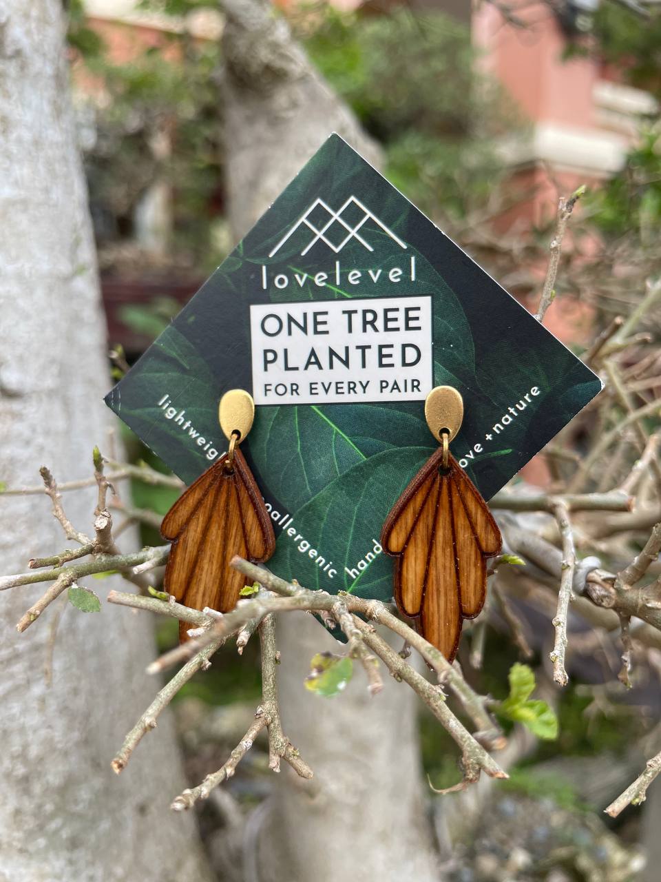 Wooden drop earrings with wooden art-deco arches dropping from a gold stud.