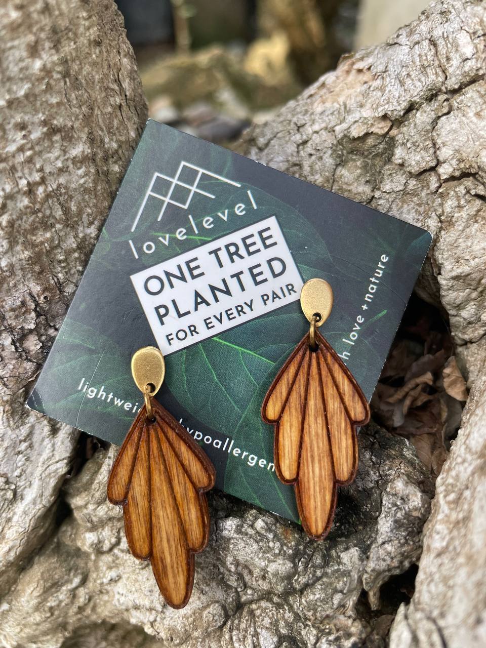 Wooden drop earrings with wooden art-deco arches dropping from a gold stud.