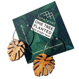 Wooden leaf-shaped earrings on a green card with 'lovelevel' branding.