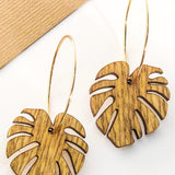 Wooden leaf-shaped earrings on a white background