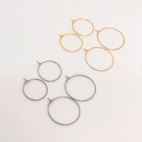 Surgical steel earring hoops, half of which are gold plated, on a white background.