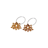 A pair of natural wooden earrings carved in the shape of lotus flowers.