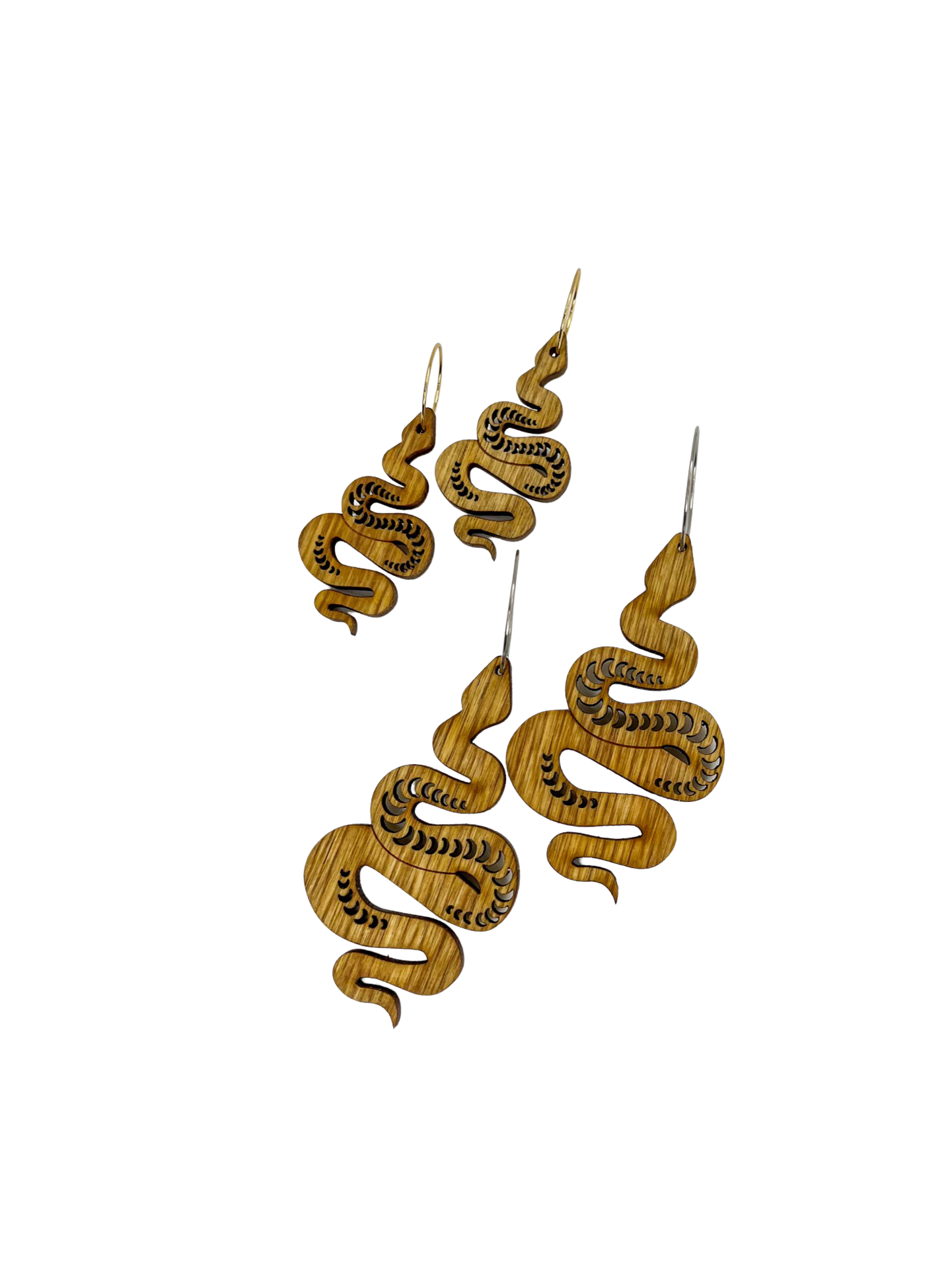 Two pairs of wooden snake earrings, one small and one large.