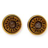 Pair of wooden circular earrings with a clear stone center on a white background
