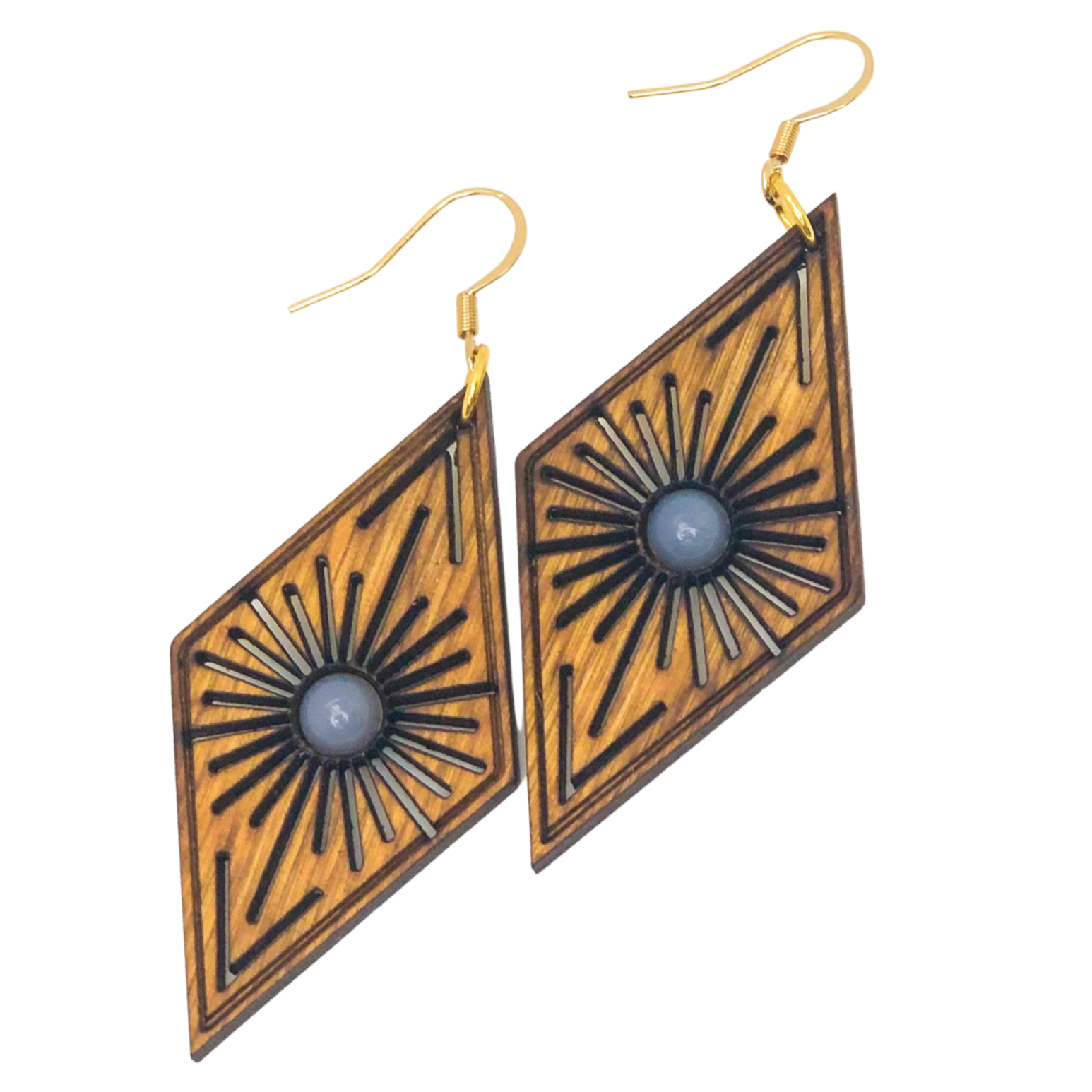Pair of geometric earrings with sunburst design on a white background