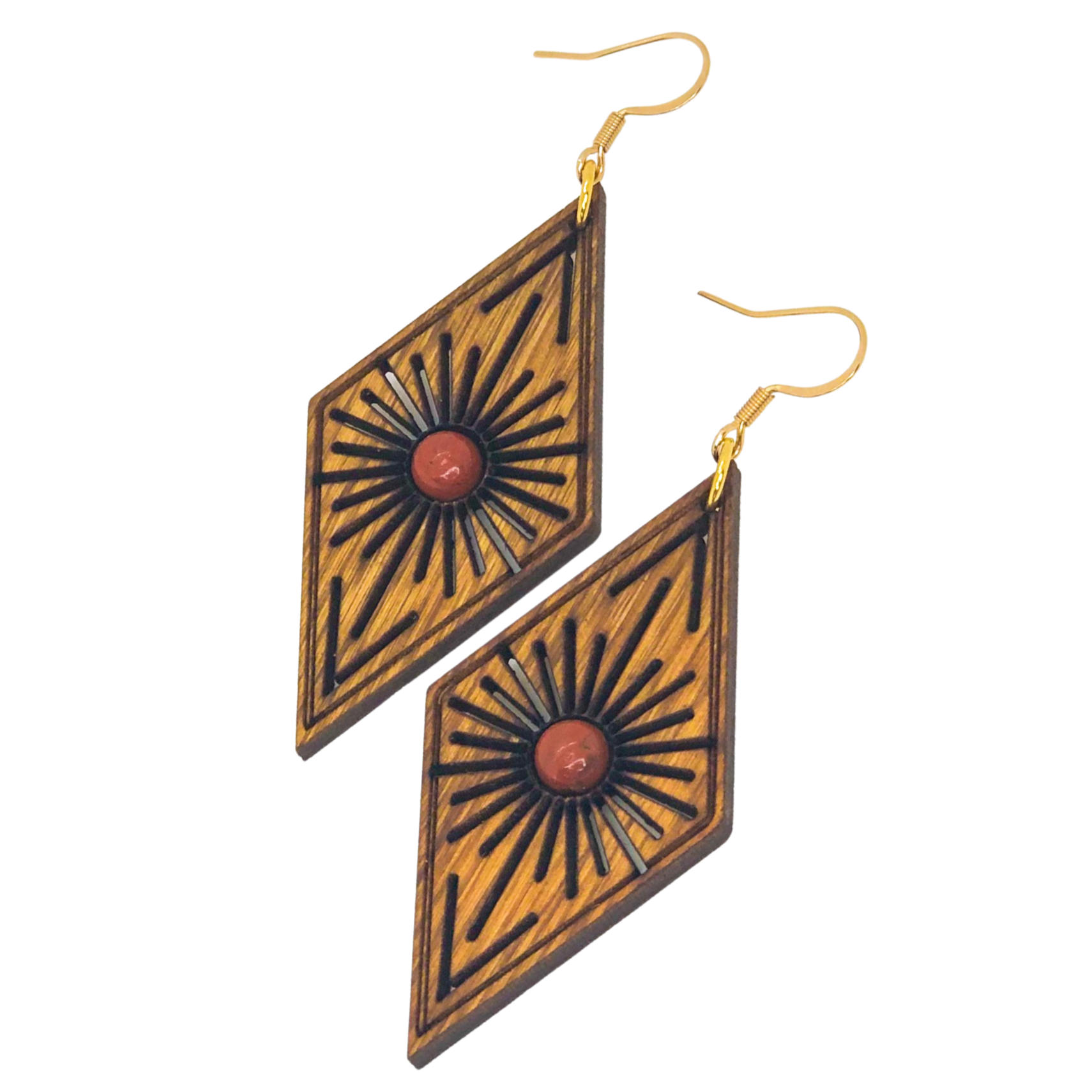 Pair of geometric earrings with wooden design and red stones on a white background