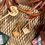 Wooden dangle earrings with a mountain peak design against a natural background.