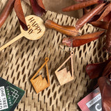 Wooden dangle earrings with a mountain peak design against a natural background.