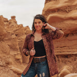 Person standing in a desert landscape with rock formations