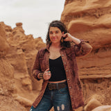 Person standing in a desert landscape with rock formations