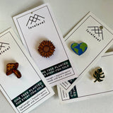 Collection of pins with a natural aesthetic on cards with 'lovelevel' branding.