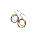 A pair of large circular earrings with a wooden circle surrounding a metal ring.