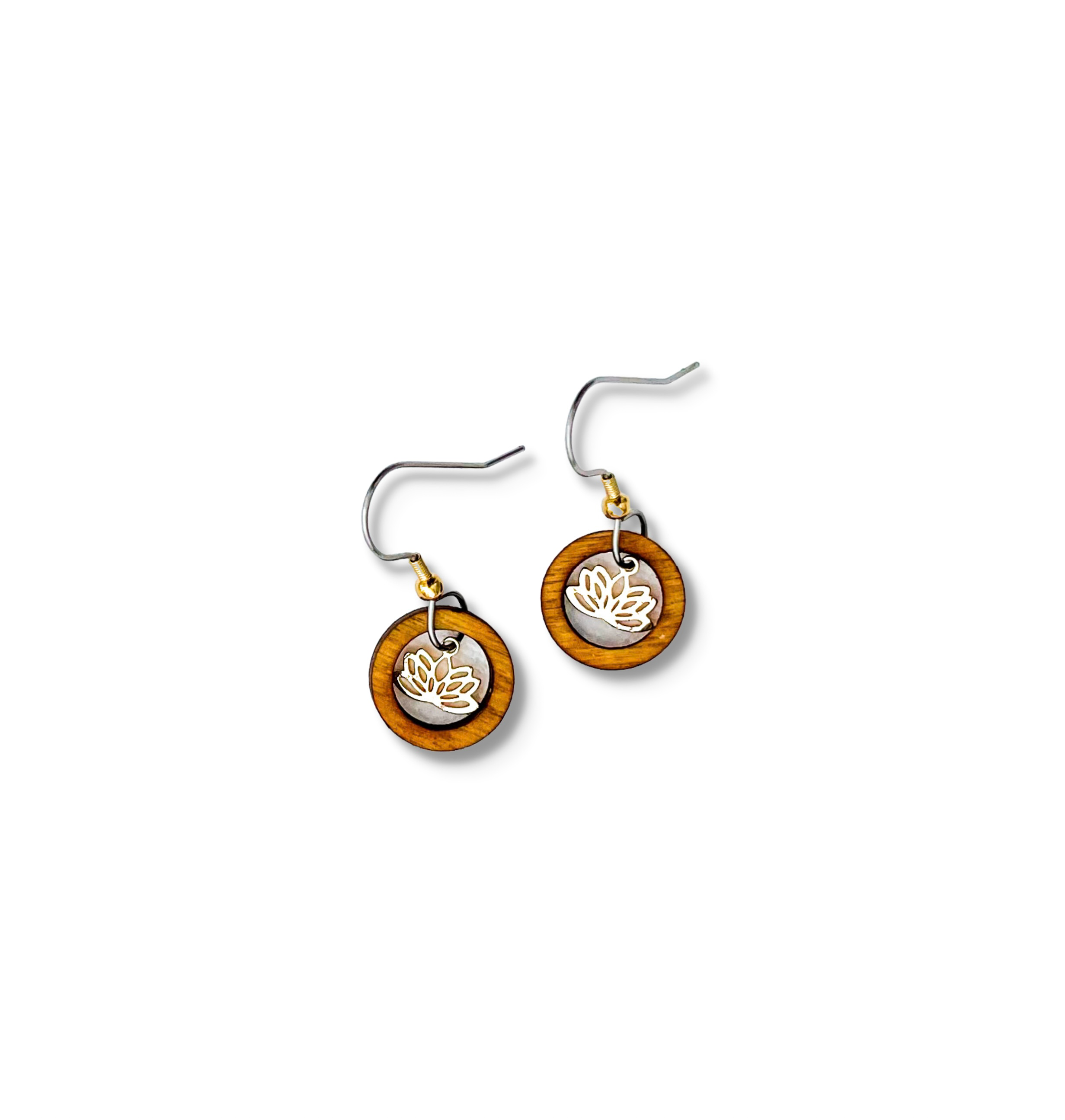 A pair of small circular earrings with a wooden ring surrounding a small gold lotus flower charm.