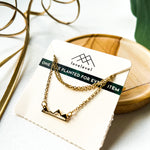 Mountain silhouette necklace on a card with 'lovelevel' branding.