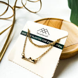 Mountain silhouette necklace on a card with 'lovelevel' branding.